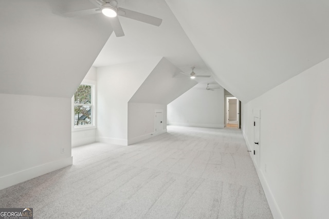 bonus room featuring vaulted ceiling, light carpet, and ceiling fan