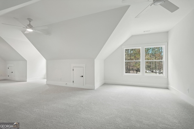 additional living space with light carpet, vaulted ceiling, and ceiling fan