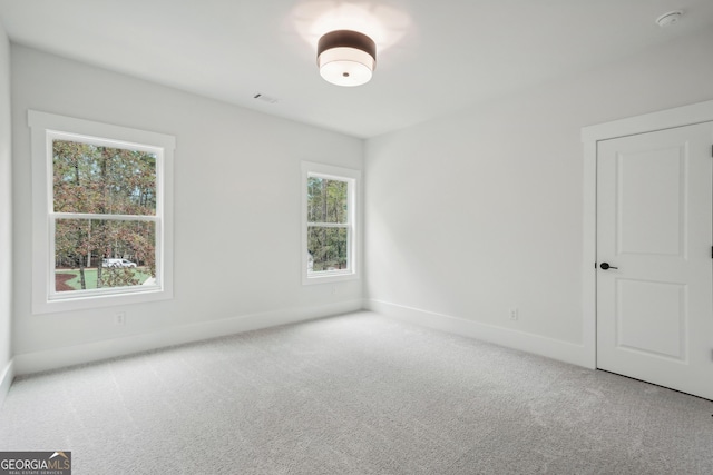 empty room featuring light carpet