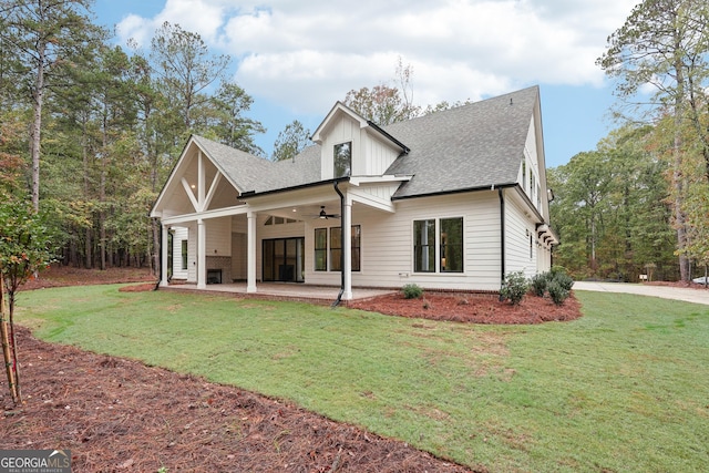 rear view of house featuring a patio, a yard, and ceiling fan