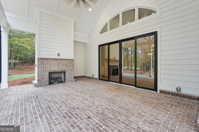 view of patio / terrace featuring an outdoor brick fireplace