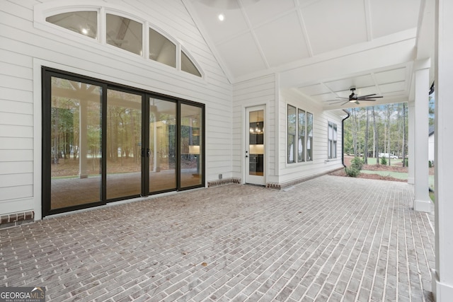 unfurnished sunroom featuring ceiling fan