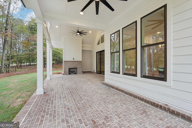 view of patio / terrace with an outdoor brick fireplace and ceiling fan