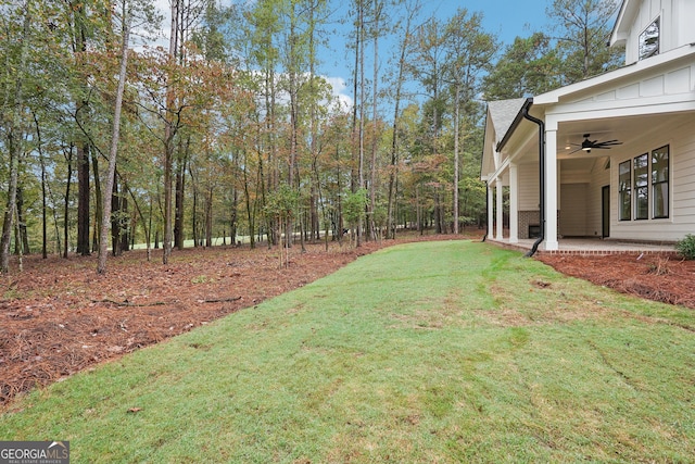 view of yard featuring a patio and ceiling fan