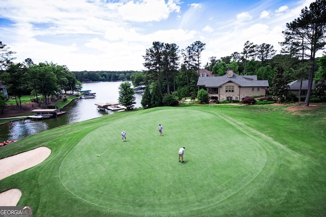 view of community featuring a water view and a lawn