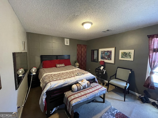 bedroom featuring carpet flooring and a textured ceiling