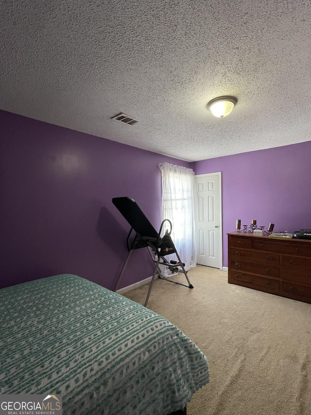 carpeted bedroom with a textured ceiling