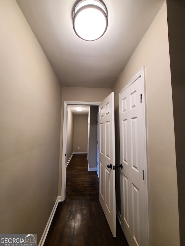 hallway with dark hardwood / wood-style floors