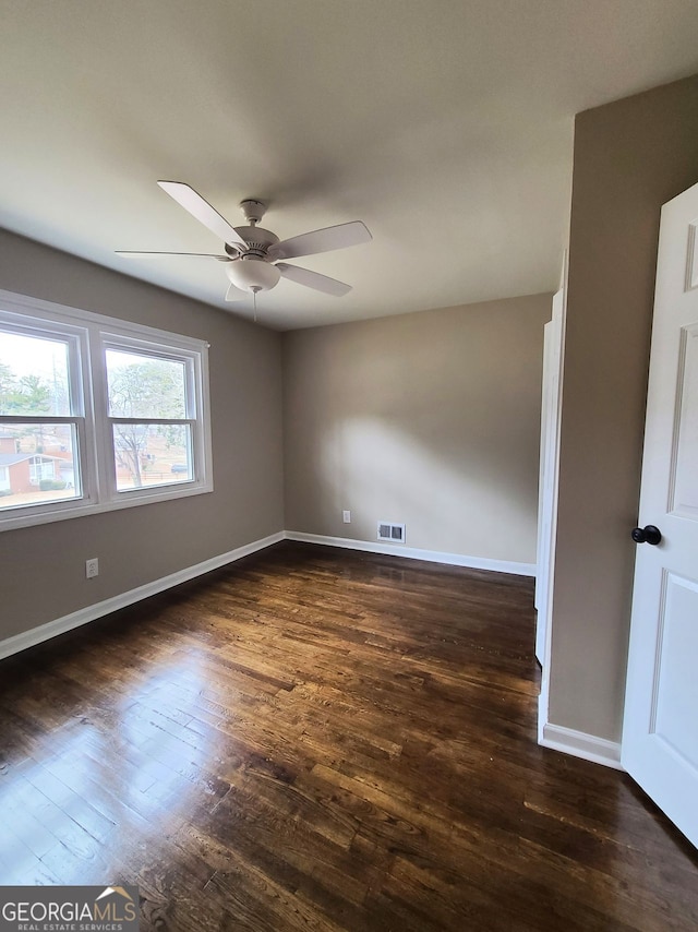 unfurnished room featuring dark hardwood / wood-style flooring and ceiling fan