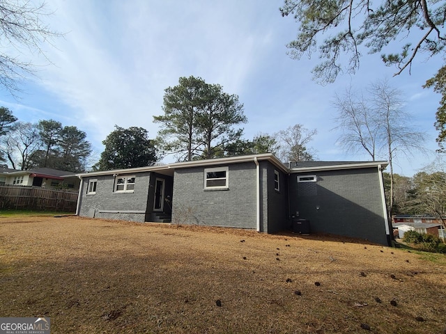 rear view of property featuring a yard