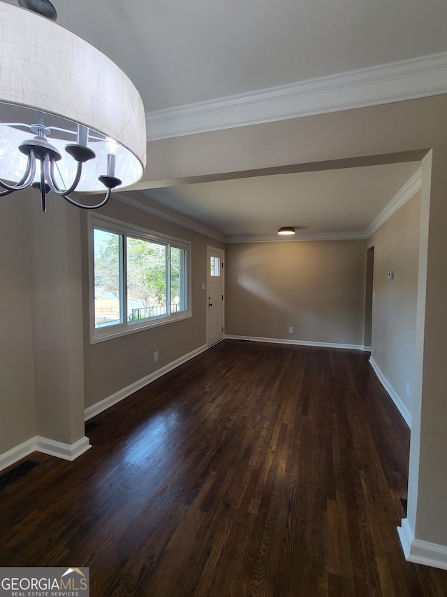 interior space with ornamental molding, dark hardwood / wood-style floors, and a chandelier