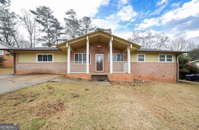 bungalow-style home featuring covered porch and a front lawn