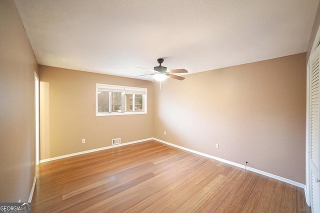 spare room with light hardwood / wood-style flooring and ceiling fan