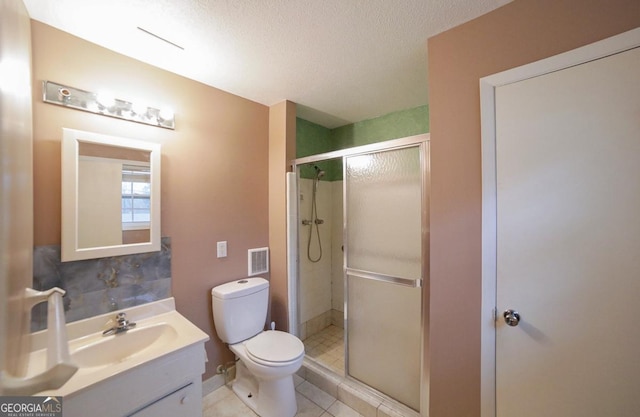 bathroom with walk in shower, vanity, toilet, and a textured ceiling