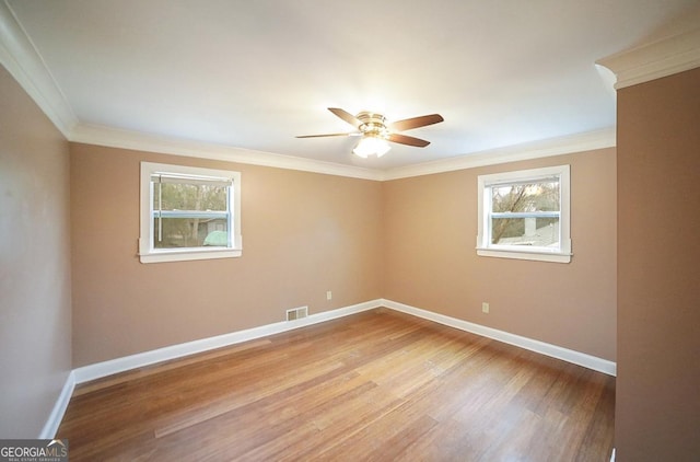 spare room featuring ceiling fan, ornamental molding, and light hardwood / wood-style flooring