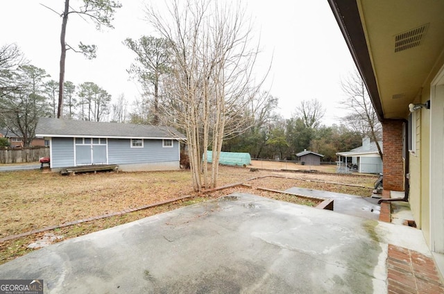 view of patio / terrace featuring a storage unit