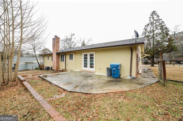 back of house with central AC unit, a patio, and french doors