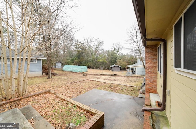 view of yard with a patio and an outbuilding