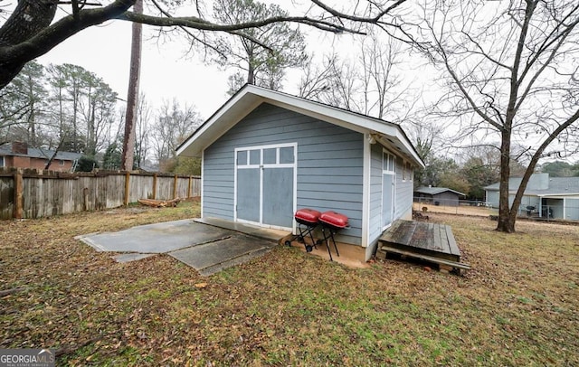 view of outbuilding with a yard