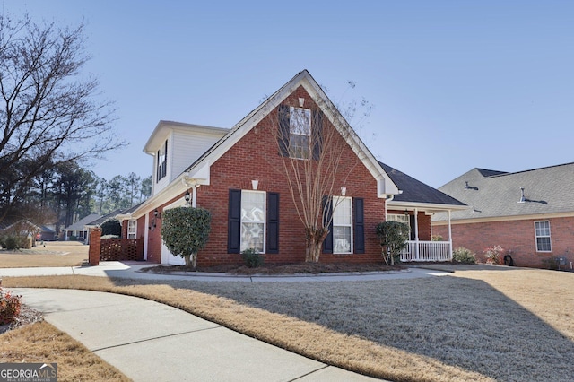 view of front of house with a porch and a front yard