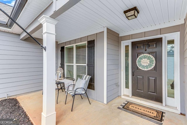 doorway to property featuring covered porch