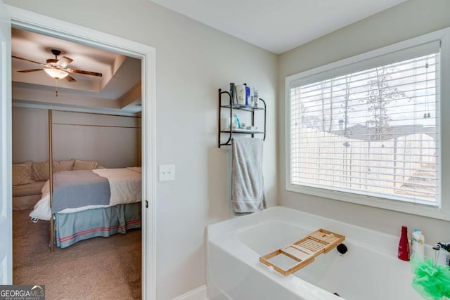 bathroom featuring a washtub and ceiling fan