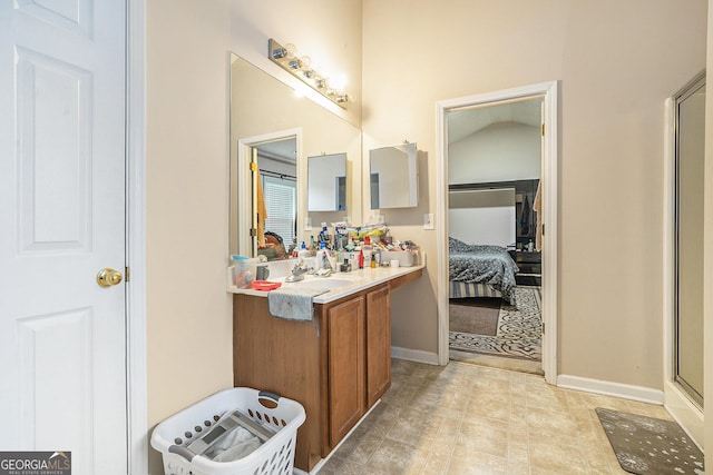 bathroom with vanity and a shower with shower door