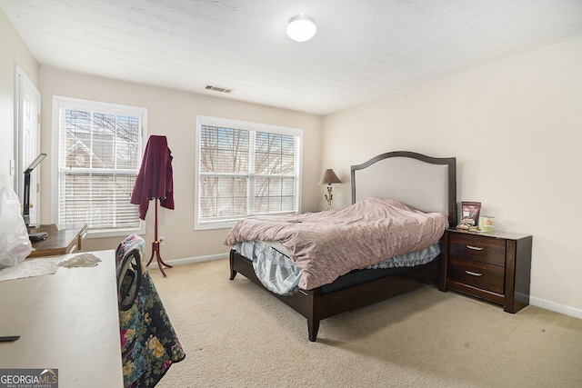 bedroom featuring light colored carpet