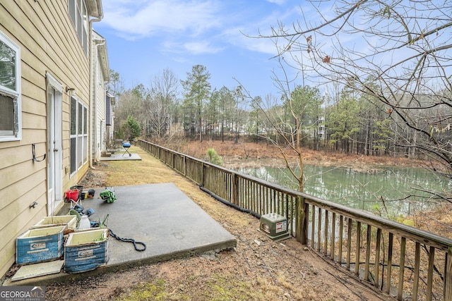 view of yard with a water view and a patio area