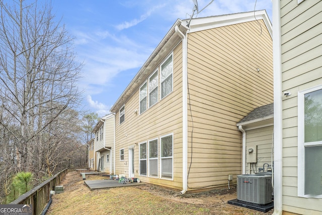 view of home's exterior with central AC and a patio