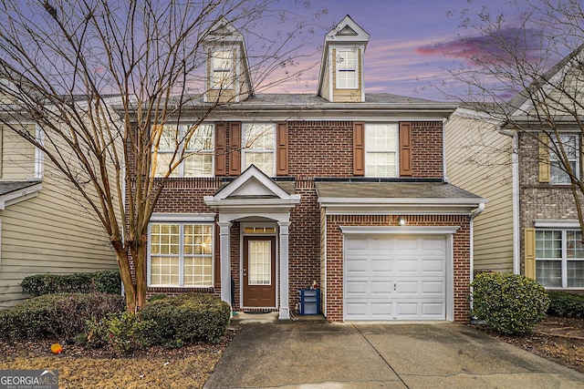 townhome / multi-family property featuring a garage