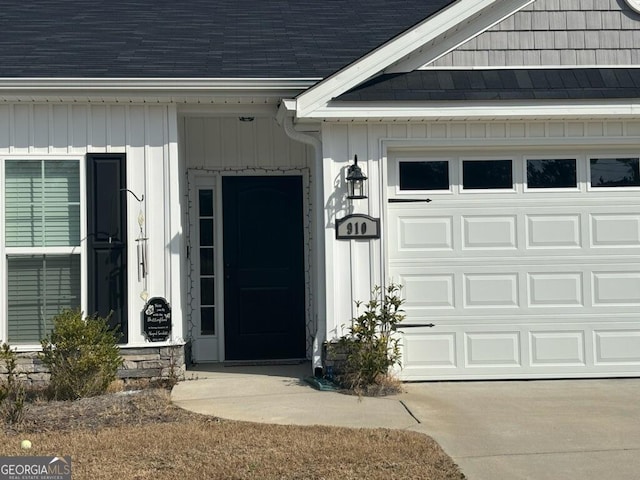 doorway to property with a garage