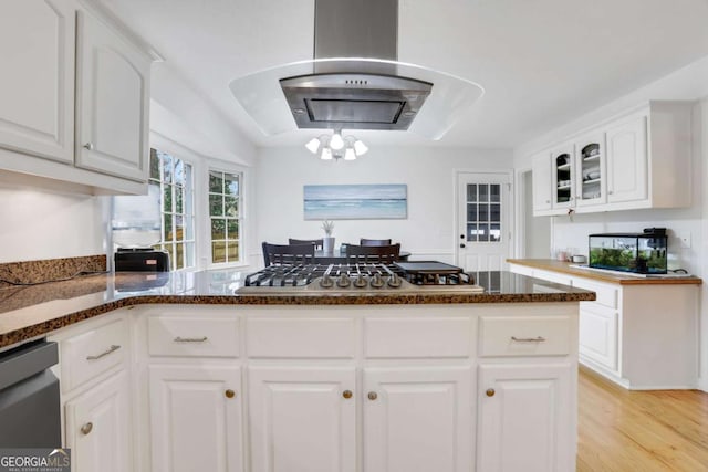 kitchen featuring stainless steel gas cooktop, white cabinetry, ventilation hood, light hardwood / wood-style flooring, and dishwasher