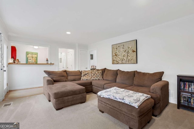 carpeted living room with ornamental molding