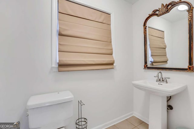 bathroom with tile patterned flooring, sink, and toilet