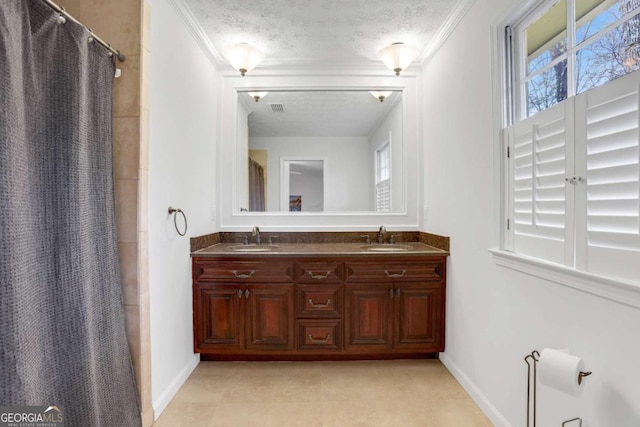 bathroom featuring vanity, a shower with curtain, ornamental molding, and a textured ceiling