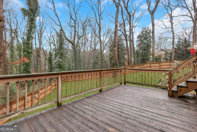 wooden deck featuring a yard