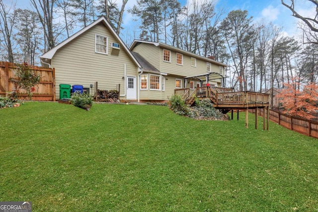 rear view of house with a yard, a deck, and a pergola