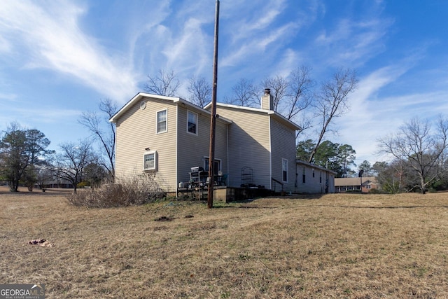 view of side of property with a yard