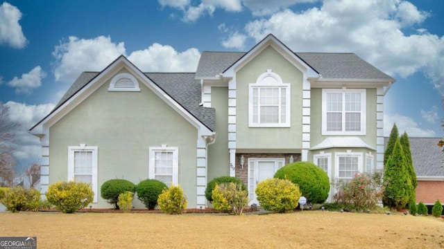 view of property featuring a front lawn