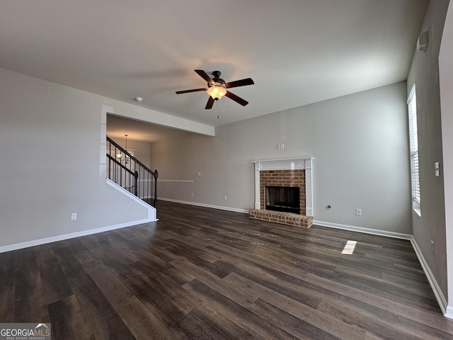 unfurnished living room with ceiling fan, dark hardwood / wood-style floors, and a fireplace