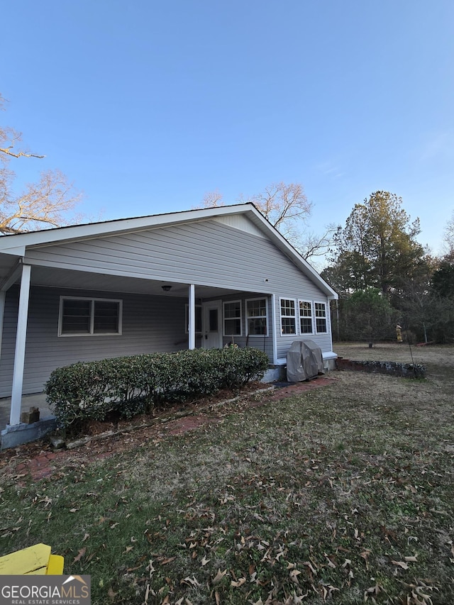 back of house with a lawn