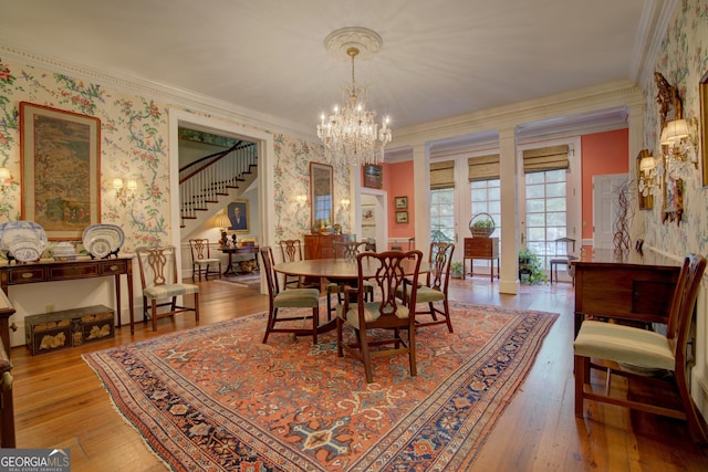 dining room featuring crown molding, a chandelier, and light hardwood / wood-style floors