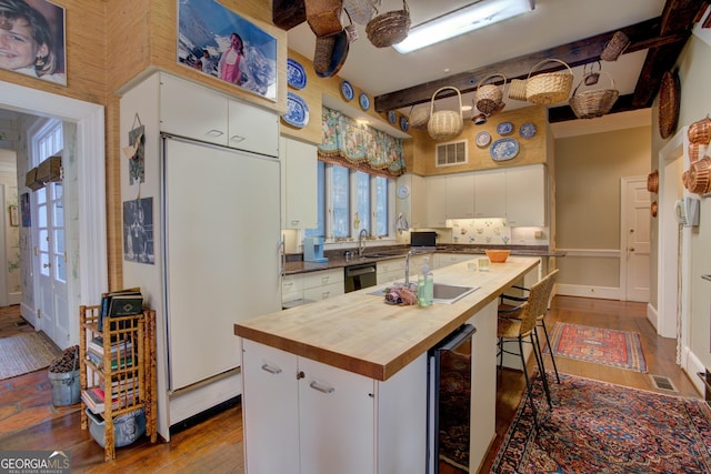 kitchen with dishwasher, white cabinetry, beverage cooler, a center island, and light wood-type flooring