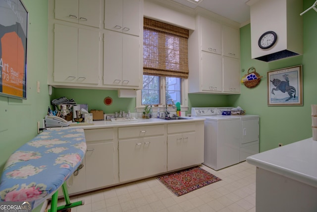 clothes washing area featuring cabinets, separate washer and dryer, and sink