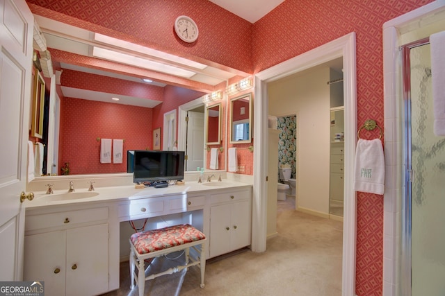 bathroom with vanity and a shower with door