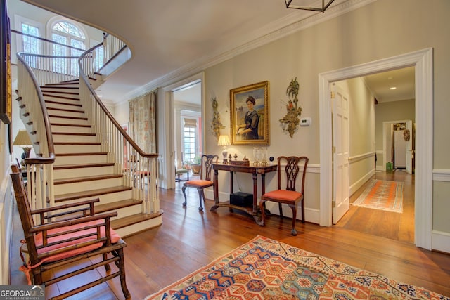 interior space with ornamental molding and wood-type flooring