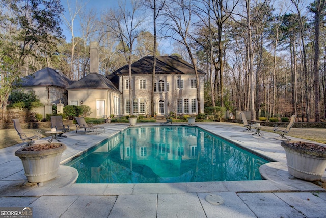 view of swimming pool featuring a patio area