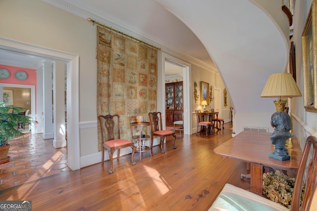 interior space featuring hardwood / wood-style flooring and ornamental molding