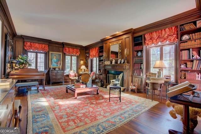 living room featuring crown molding, hardwood / wood-style floors, and built in features